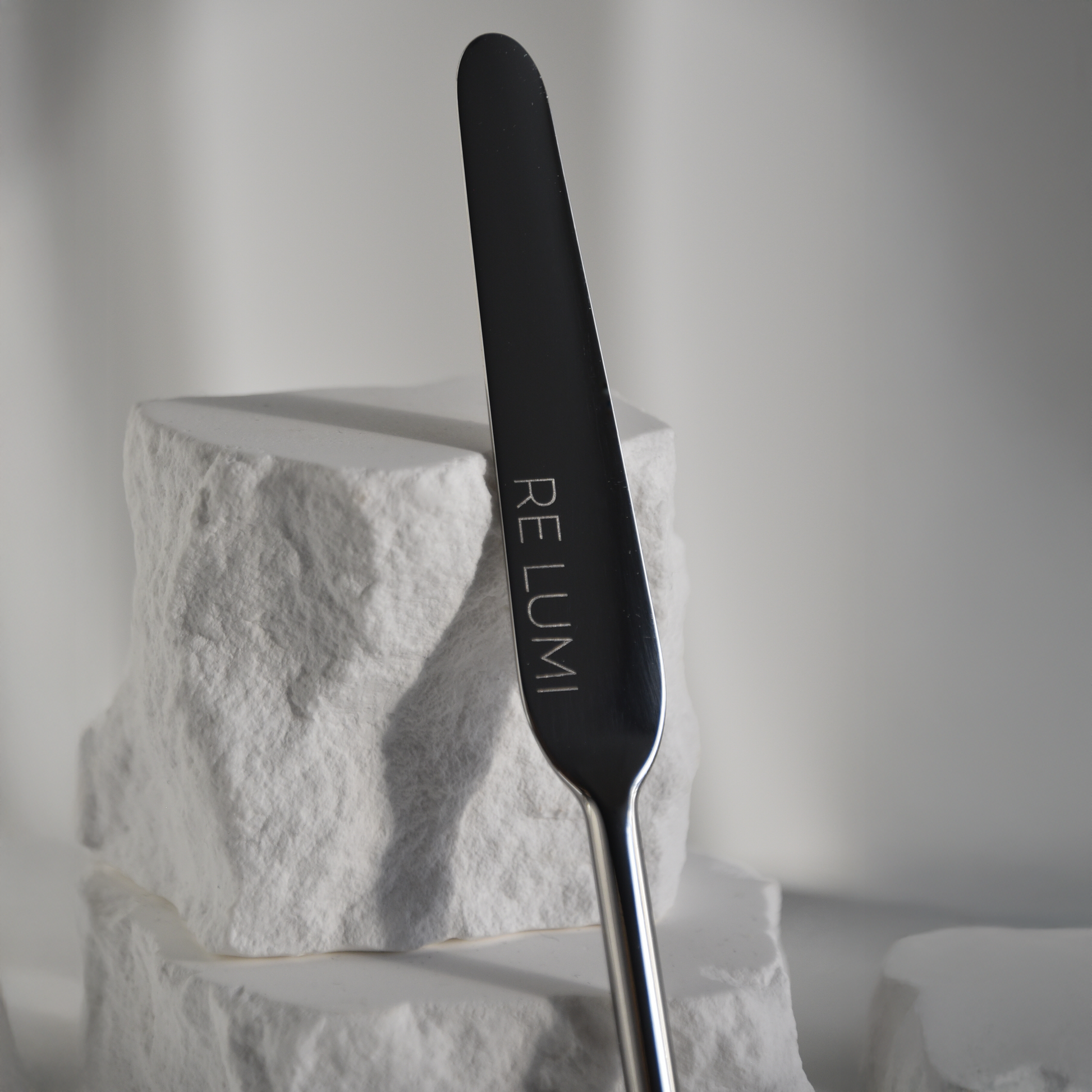 Silver stainless spatula zoomed in  with whine stone background